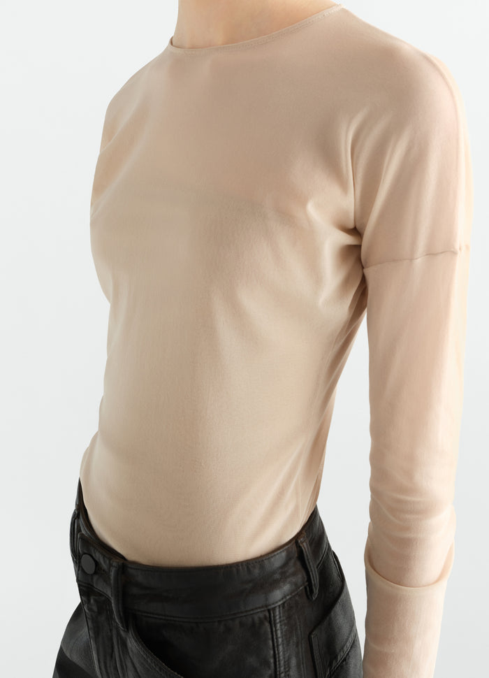 Long-sleeve ballerina-style beige mesh jersey top by LEMAIRE worn by model, close-up front side view