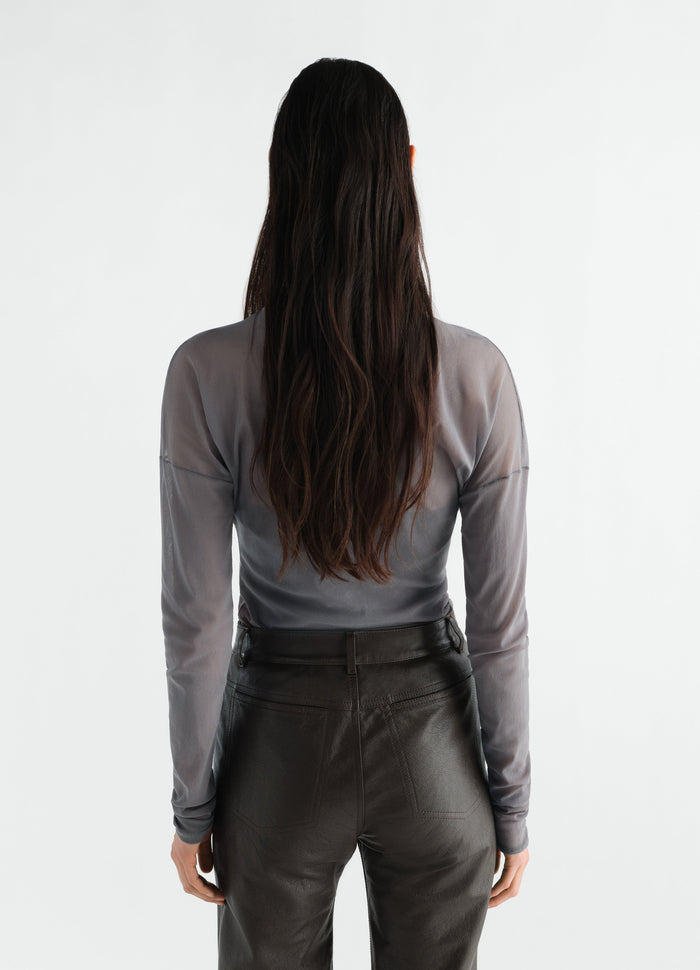 Long-sleeve grey mesh jersey top LEMAIRE worn by model back view with black leather pants on white background