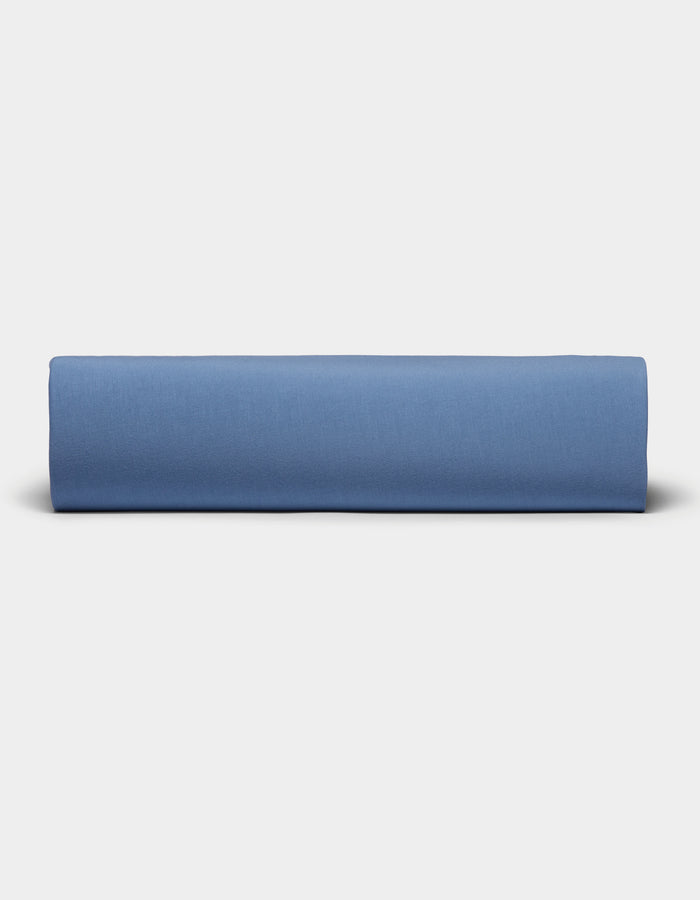 A neatly folded Bamboo Jersey Sheet Set by Cozy Earth is displayed against a plain, light gray background.|Color:Sailor