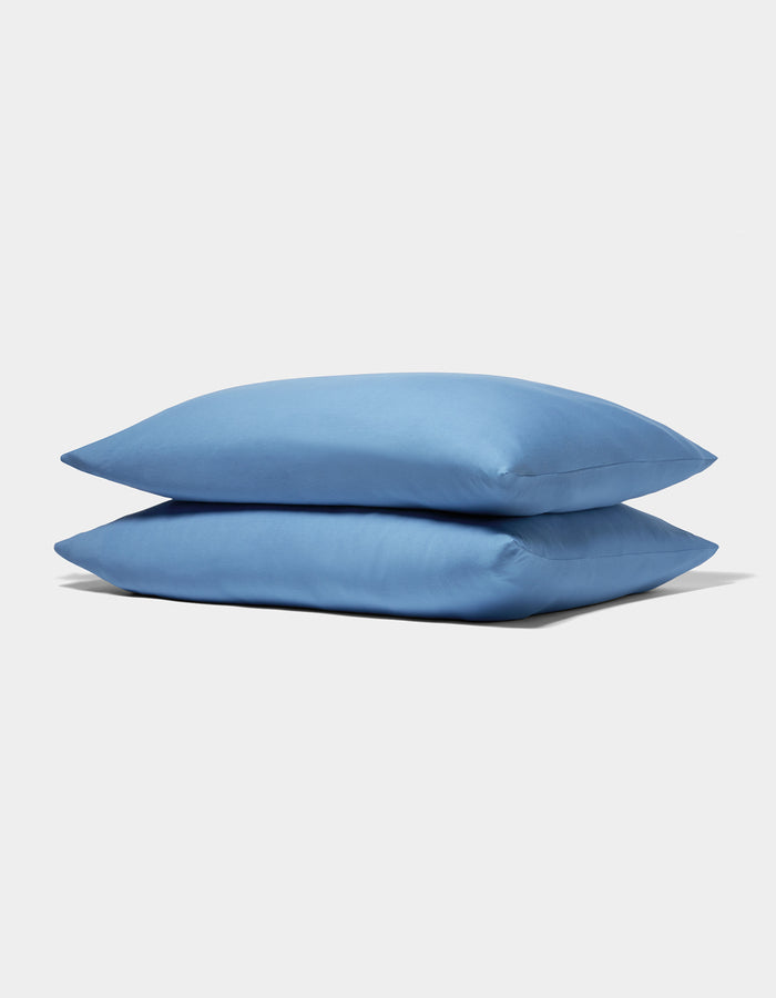Two neatly stacked Cozy Earth Bamboo Jersey Pillowcases in light blue are displayed on a plain white background.|Color:Sailor