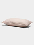 The Cozy Earth Bamboo Jersey Quilted Shams features a light pink rectangular design with a quilted pattern, displayed on a plain white background.|Color:Petal