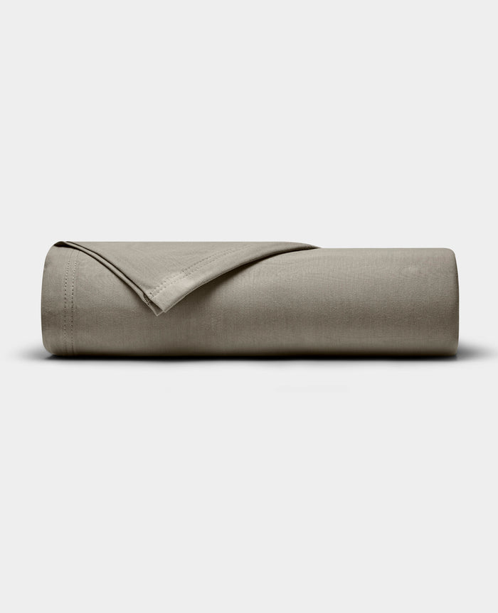 The Cozy Earth Bamboo Jersey Flat Sheet, shown neatly folded in taupe, is displayed on a plain white background.|Color:Stone