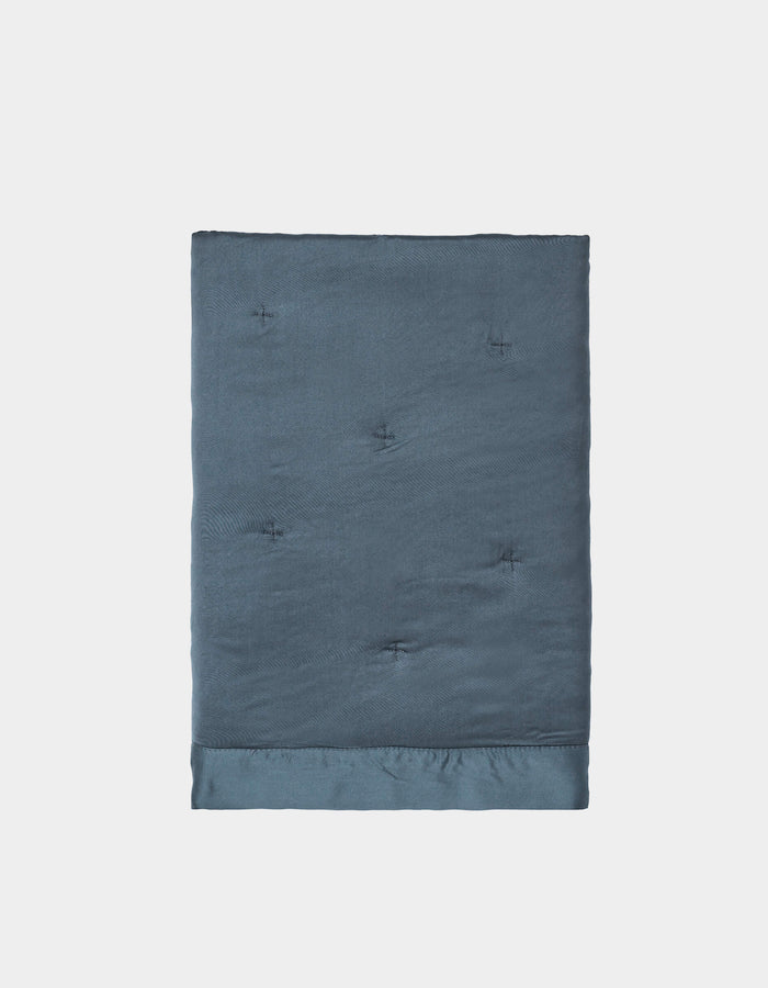 A pair of neatly folded, dark blue Bamboo Quilted Shams by Cozy Earth, featuring a smooth, slightly shiny texture and subtle tufted details, displayed against a plain white background.|Color:Pacific Blue