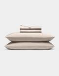 A neatly stacked Cozy Earth Bamboo Sheet Set, featuring two pillows, a folded fitted sheet, flat sheet, and pillowcases, displayed against a plain white background.|Color:Driftwood