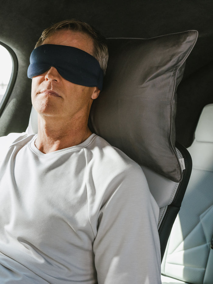 Man with sleep mask laying on travel pillow with charcoal case in the car |Color:Charcoal