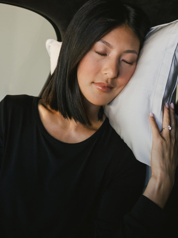 Woman laying on light grey travel pillow in the car |Color:Light Grey