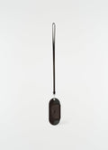 Glasses case in dark brown glossy vegetable-tanned leather with strap by LEMAIRE front on white background