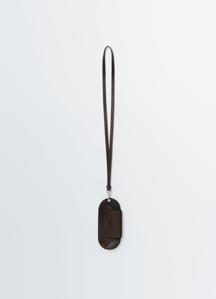 Bell glasses holder in dark brown leather with strap by LEMAIRE front on white background