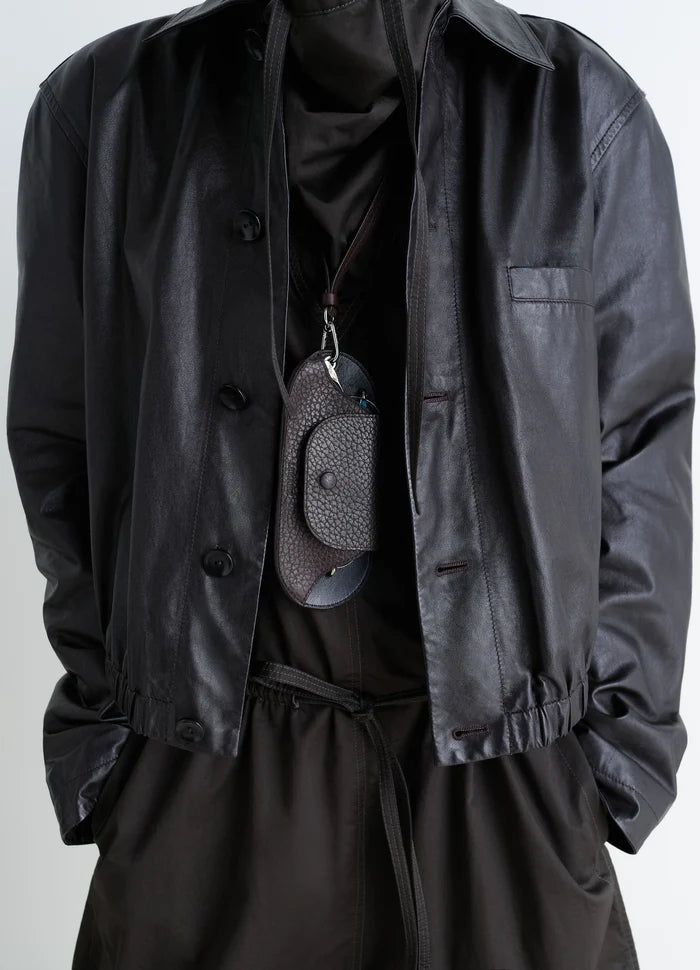 Bell Glasses Holder in Grained Leather, model shot, hanging front angle textured closure flap