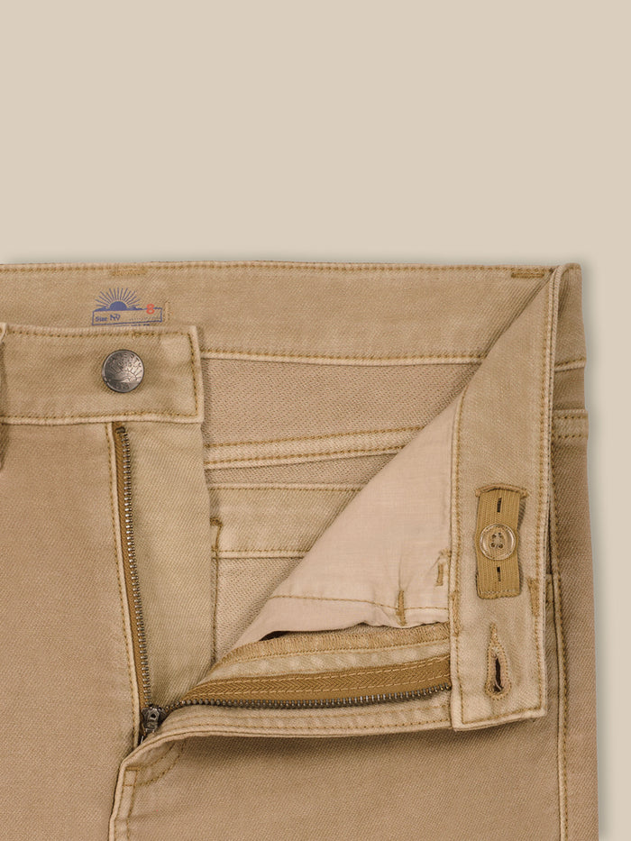 Close up of beige pants with an adjustable waistband