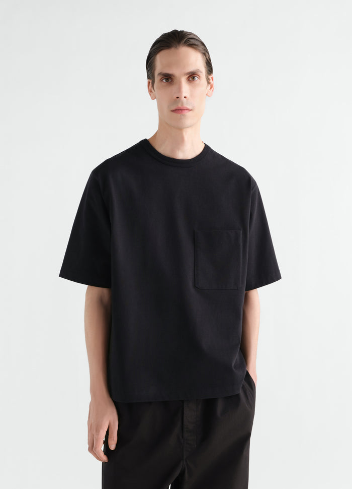 Boxy black cotton jersey T-shirt with pocket LEMAIRE worn by model front view main look