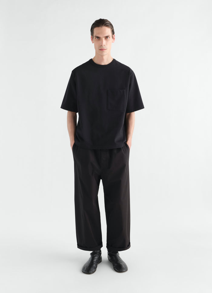 Boxy black cotton jersey T-shirt LEMAIRE with chest pocket worn by model front view