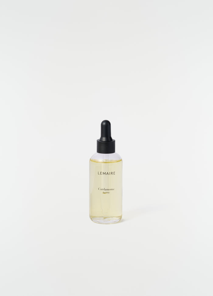 Cardamome Terre scented oil dropper bottle with black cap by LEMAIRE on plain white background