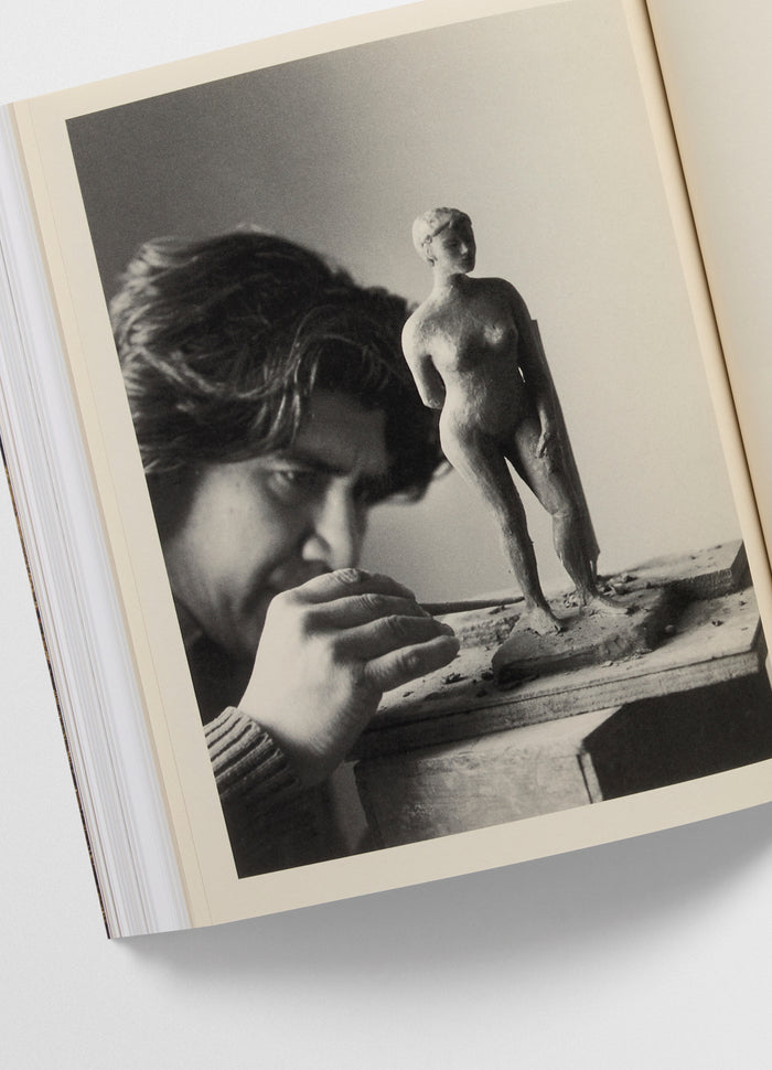 Carlos Peñafiel Book by LEMAIRE styled with black and white photo of sculptor working on clay figure
