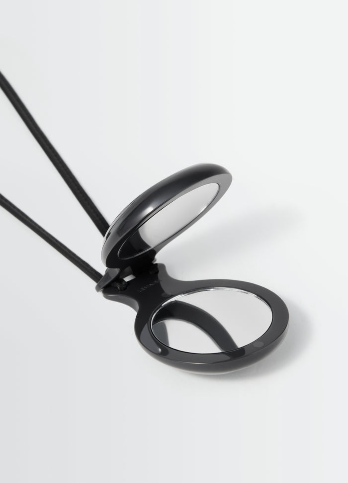 Castanet mirror black resin with two round mirrors and leather cord by LEMAIRE close-up on white background