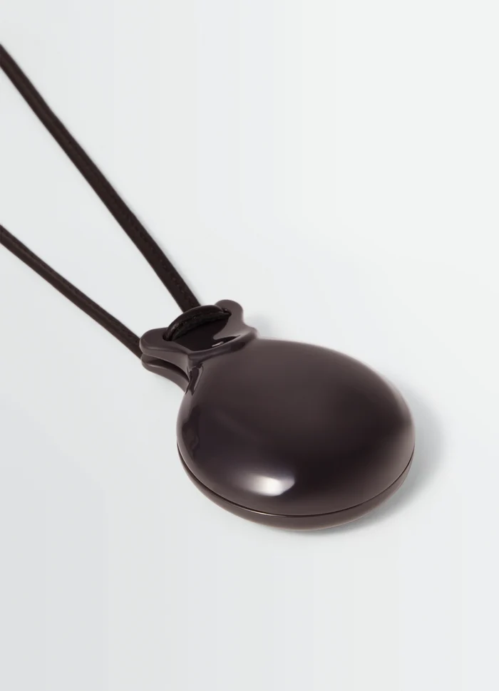 CASTANET MIROR necklace in Dark brown material, product shot, angled view smooth polished surface