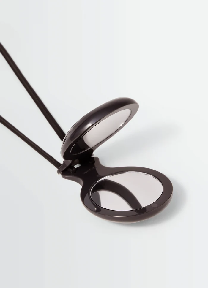 CASTANET MIROR necklace in Dark brown material, product shot, top angle view open mirror detail