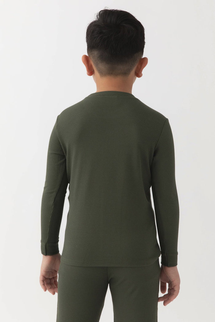 A young boy with short dark hair, seen from behind, wears the Cozy Earth Children's Bamboo Waffle Knit Base Layer Long Sleeve in olive green. The background is plain white.|Color:Olive