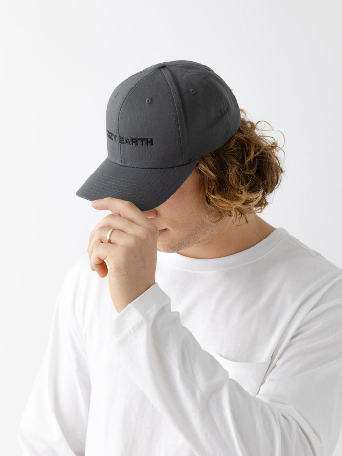 A man wearing a grey cap with 'COZY EARTH' text on a white background |Color:Charcoal/Black