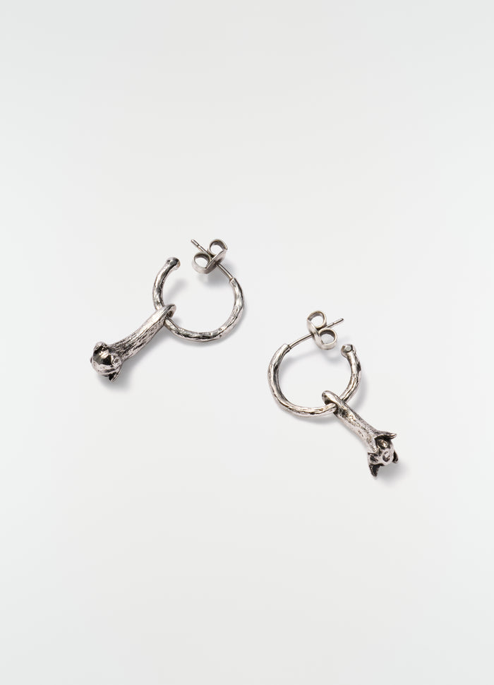 Clove silver hoop earrings with textured finish by LEMAIRE styled on plain white background