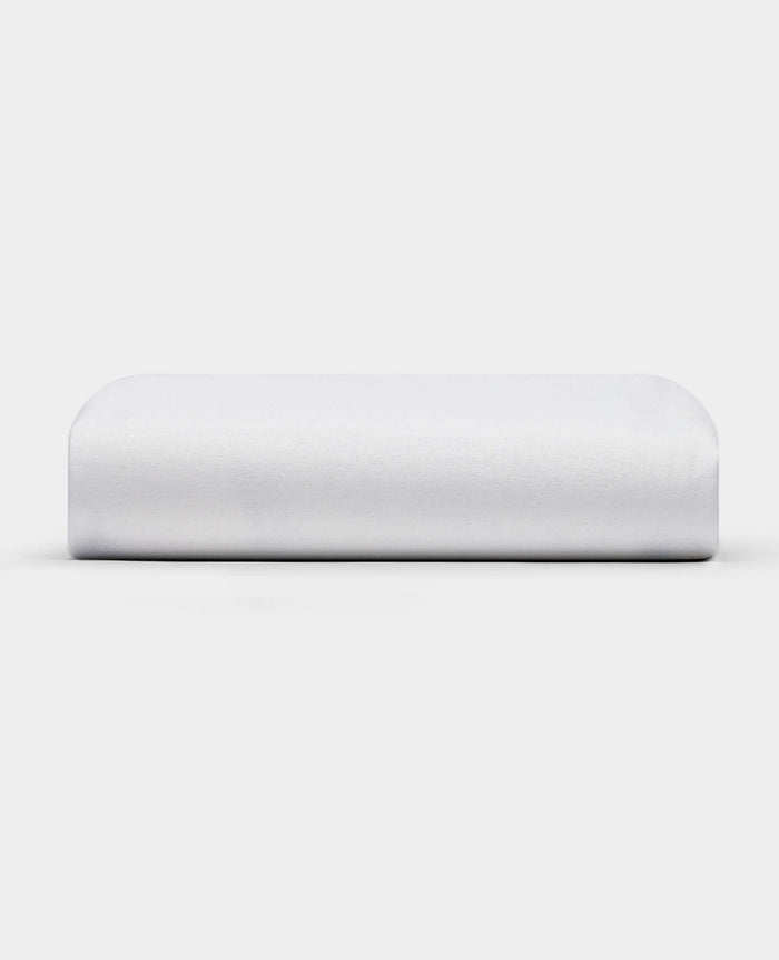 The Cozy Earth Cooling Mattress Protector is shown against a plain white background. It appears firm, rectangular with smooth, rounded edges, and has a crisp white finish.