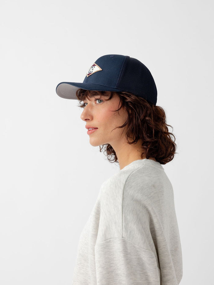 Side view of woman wearing navy diamond mesh trucker hat |Color:Navy