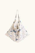 Cream tote bag with a blue limited edition percussion print on a white background