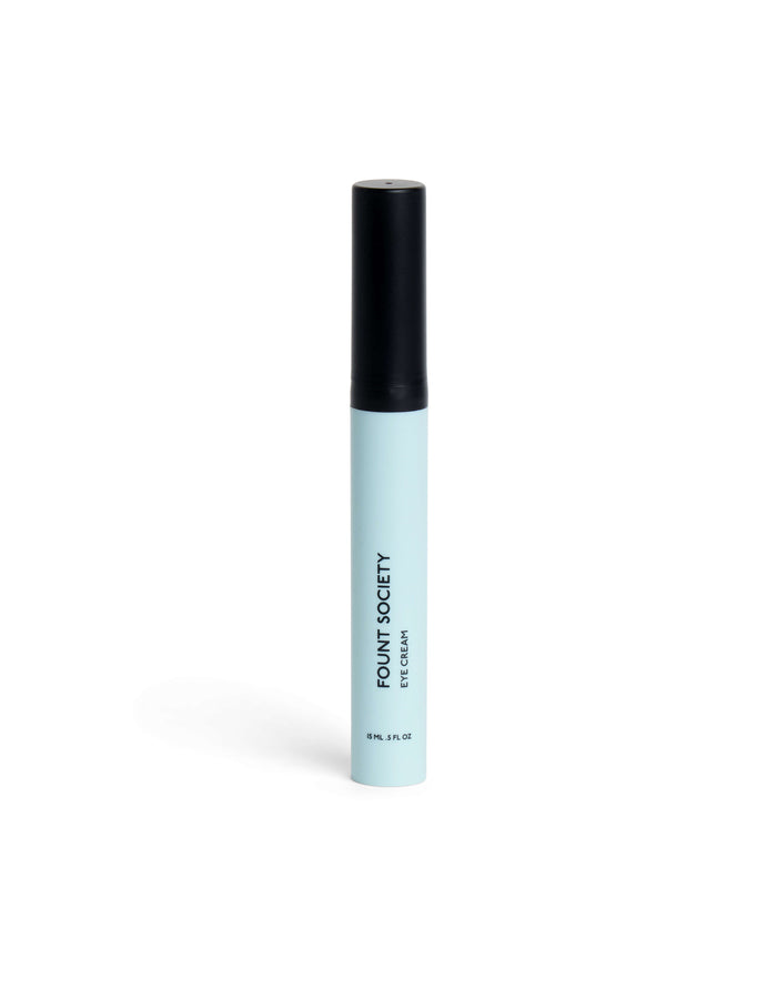 A light blue cylindrical tube with a black cap, labeled "Cozy Earth Eye Cream" in black text, stands upright on a white background.