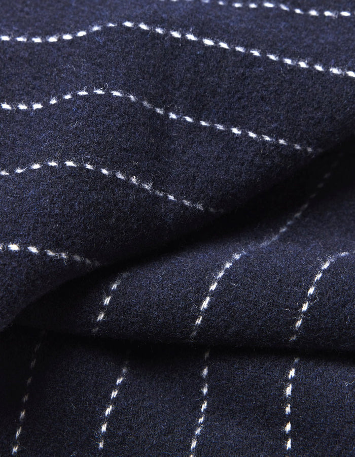 Close-up of Cozy Earth's Florence Throw in dark navy blue, featuring white dashed lines forming a subtle grid pattern. The soft fabric is shown slightly folded. |Color:Navy