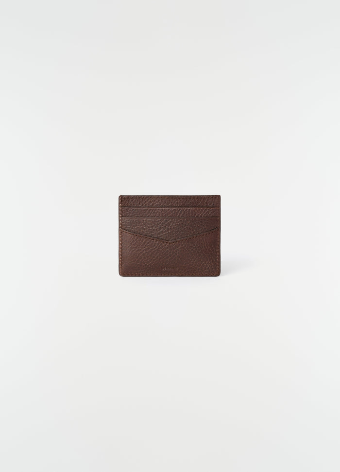 Leather brown card holder with embossed logo by LEMAIRE front view on white background