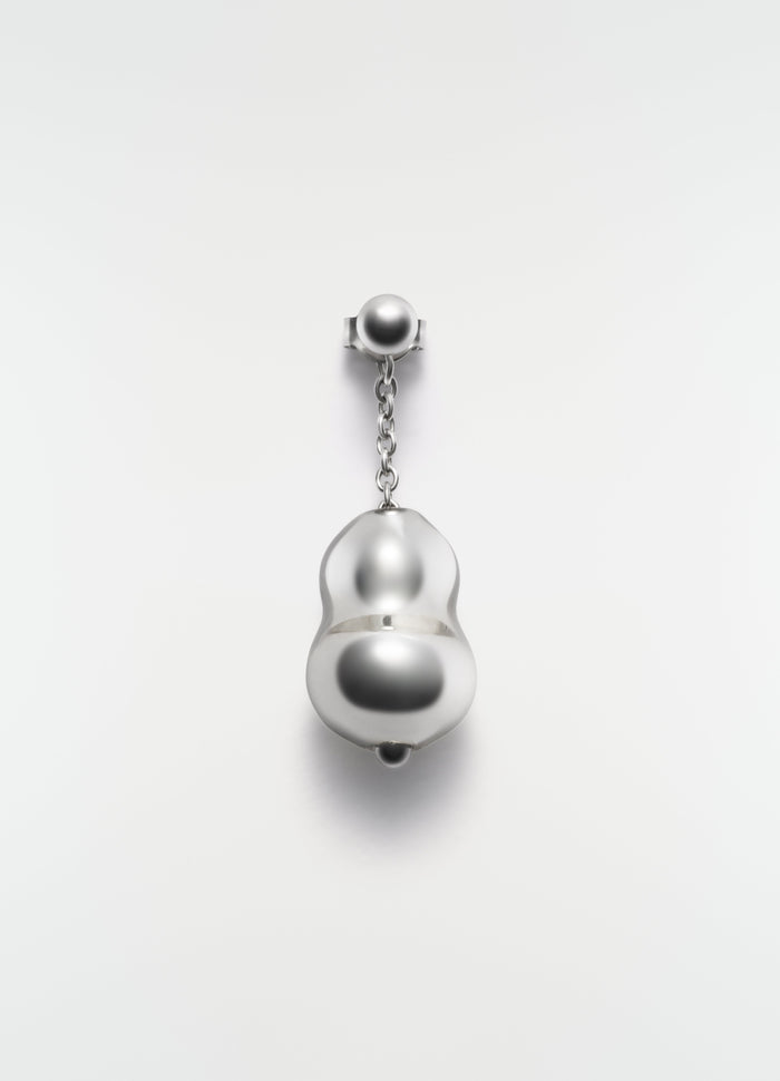 Blown glass silver-tone earring with chain detail by LEMAIRE on plain white background close-up