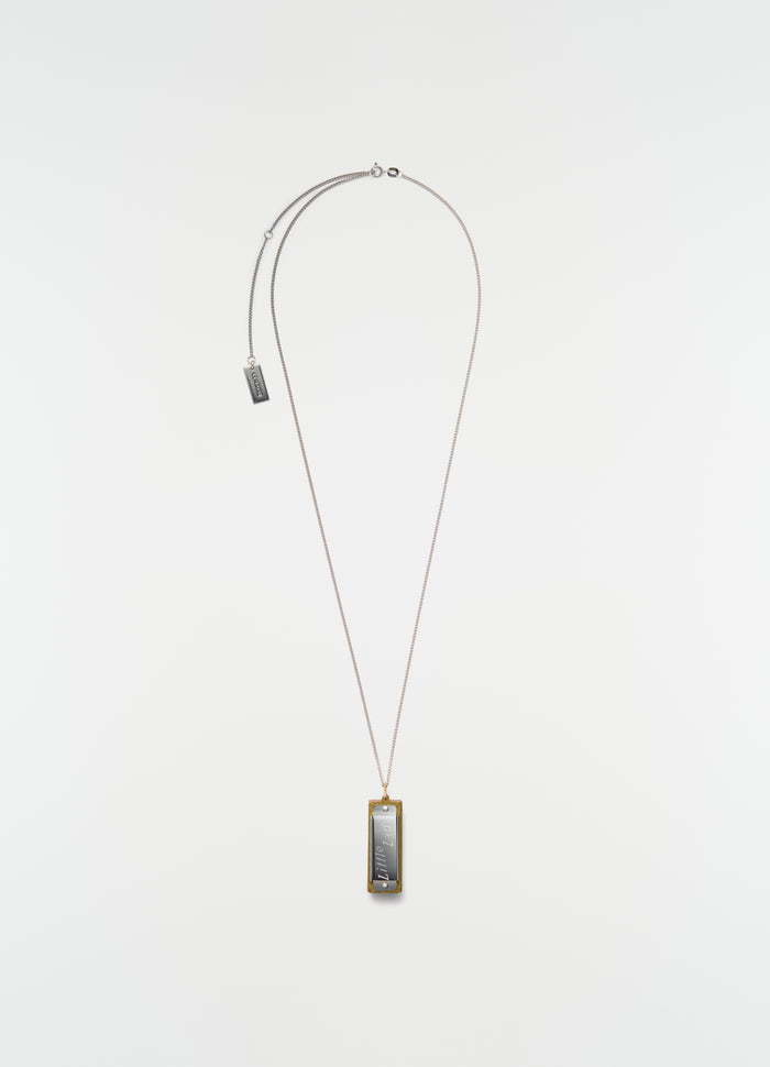 Harmonica necklace LEMAIRE silver and gold metal detail plain white background