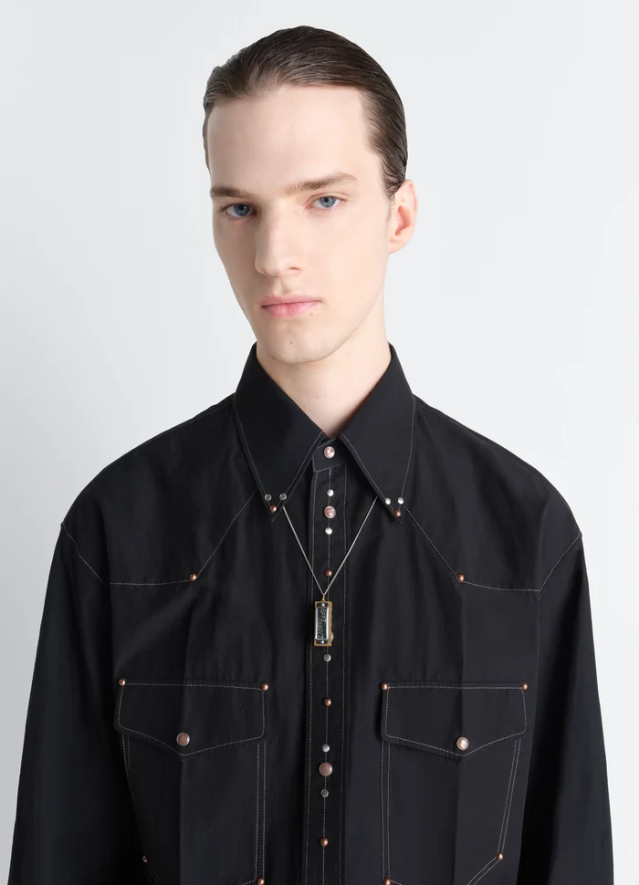 Lemaire Harmonica Necklace in Gold Silver Metal, model shot, worn close-up paired with black shirt