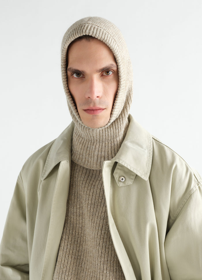 Beige alpaca and yak wool blend balaclava by LEMAIRE worn by model with beige coat front view