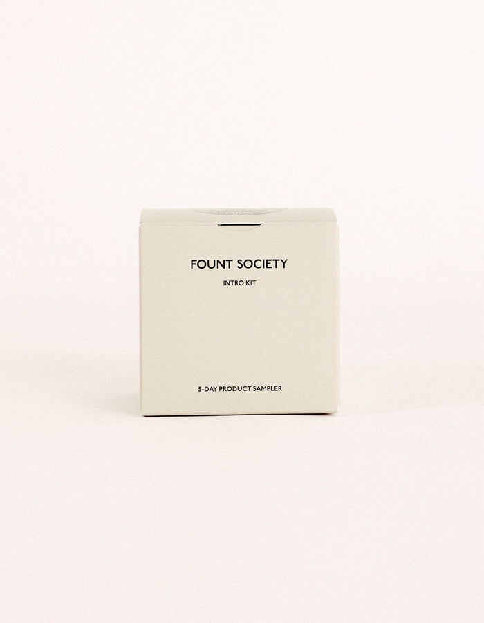 A minimalist beige box labeled "Fount Society Intro Kit" by Cozy Earth rests on a plain light background.