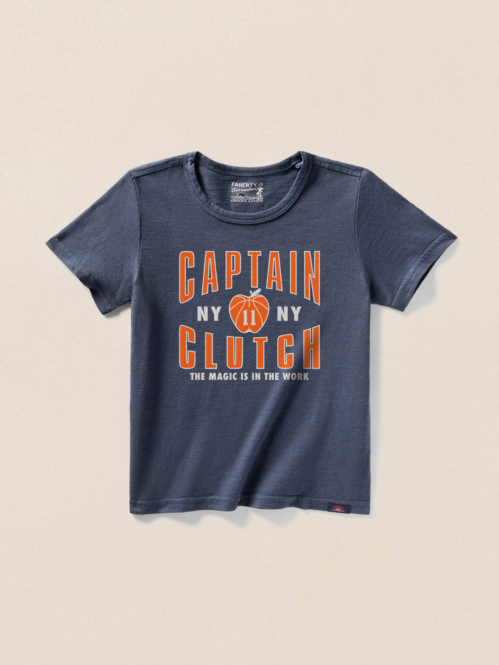 Navy blue t-shirt with a "Captain Clutch" graphic on the center front against a beige background