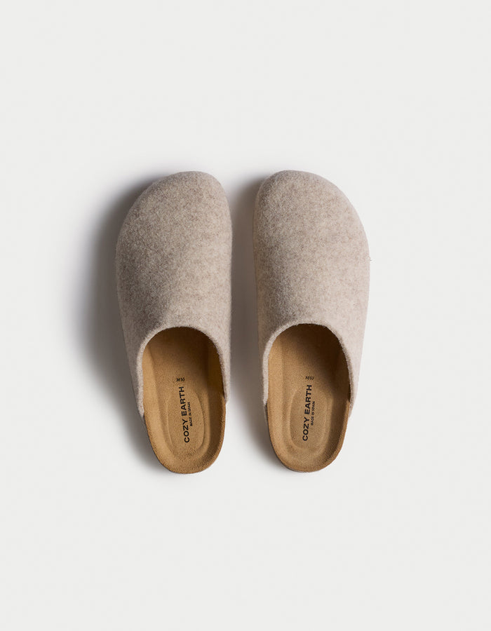 A top-down view of Cozy Earth's Lakehouse Clog, a pair of beige slip-on slippers with a soft texture and simple rounded design, set against a white background. |Color:Oat