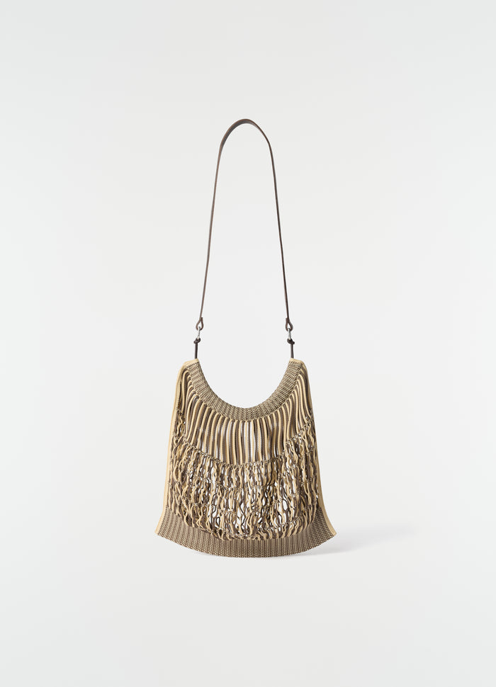Large beige cotton net shopping bag with brown leather strap by LEMAIRE front view on white background