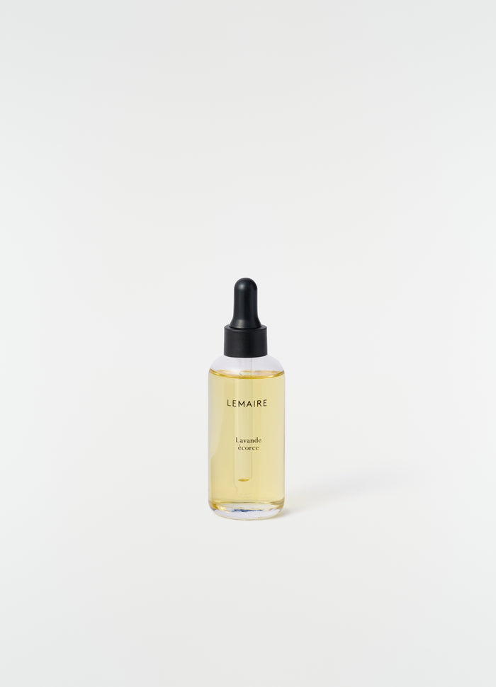 Lavande Écorce dropper bottle with yellow liquid by LEMAIRE on plain white background close-up