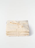 Lavender cushion S in beige cotton with tied detail by LEMAIRE on plain white background