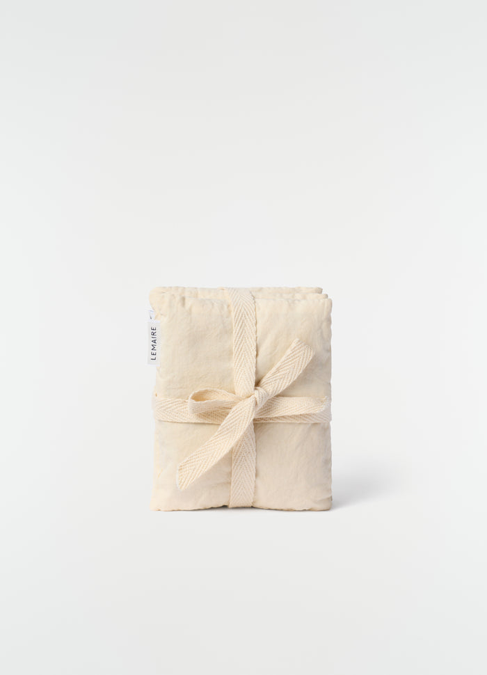 Lavender cushion XS LEMAIRE in natural cotton with tied fabric ribbon on plain white background