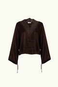 Brown lace-lined long sleeve top on a white background
