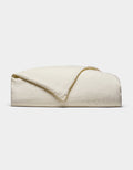 The Cozy Earth Linen Duvet Cover, in an off-white shade, is neatly folded against a white background. Its soft, slightly textured fabric is visible with one corner casually turned over.|Color:Flax