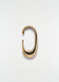 Long gold vermeil drop earcuff by LEMAIRE on plain white background close-up detail