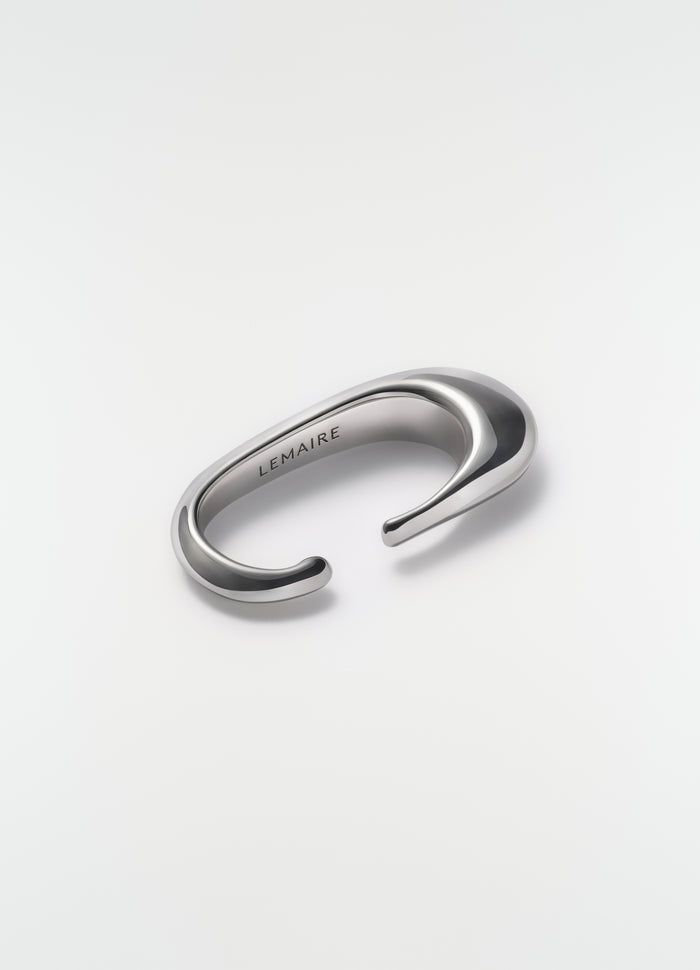 Long Drop Earcuff in silver metal LEMAIRE styled on plain white background close-up detail