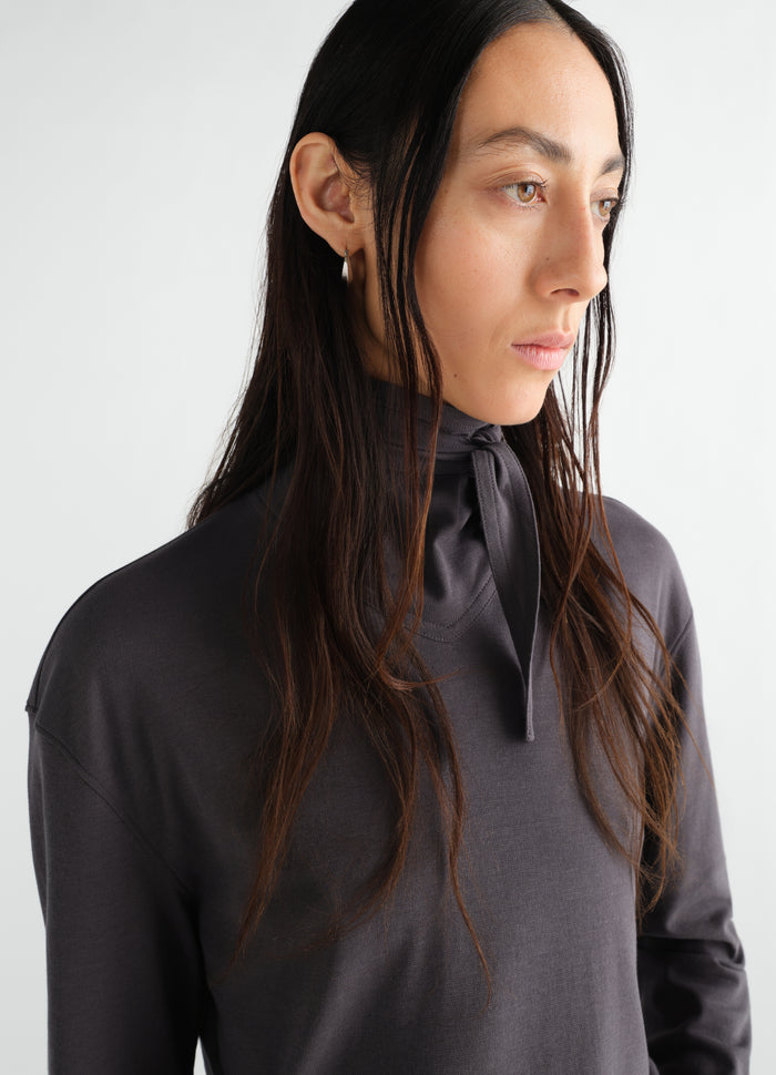 Long-sleeve scarf top in charcoal silky jersey crepe by LEMAIRE worn by a model side view close-up