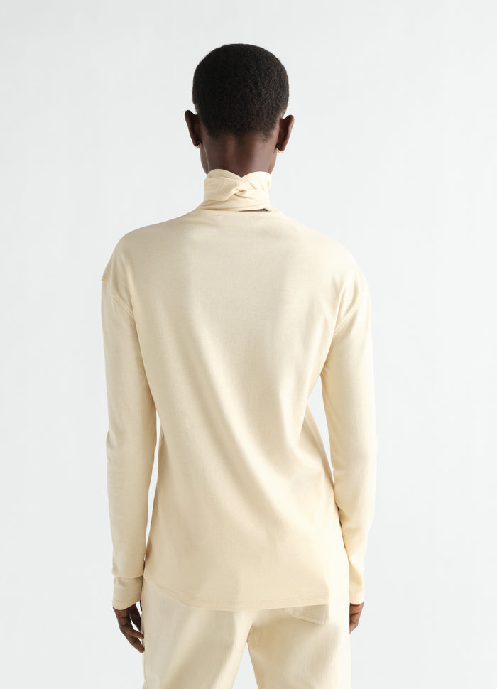 Long-sleeve beige silky jersey crepe scarf top by LEMAIRE worn by model back view