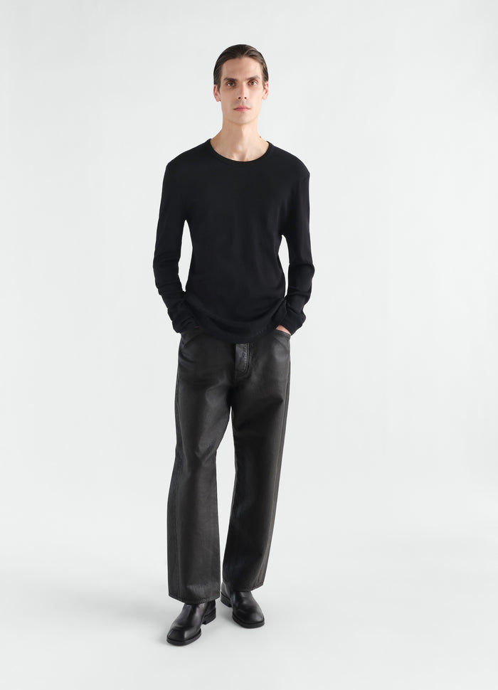 Long-sleeve black ribbed jersey top LEMAIRE worn by a model front view with black leather pants and shoes