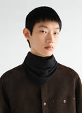 Triangular scarf in black fine merino wool by LEMAIRE worn by model front close-up detail