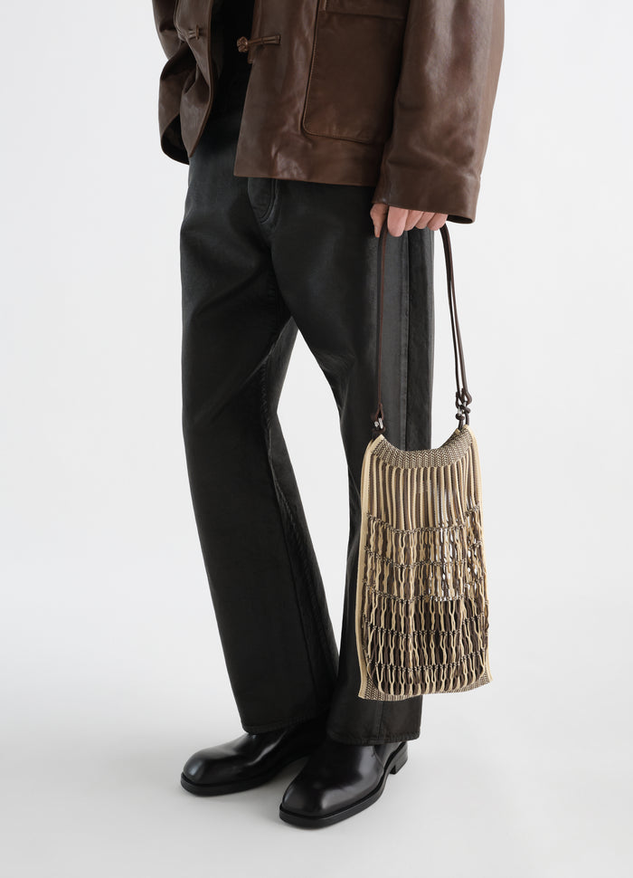 Medium filt net shopping bag beige cotton with brown leather strap LEMAIRE worn by model side view
